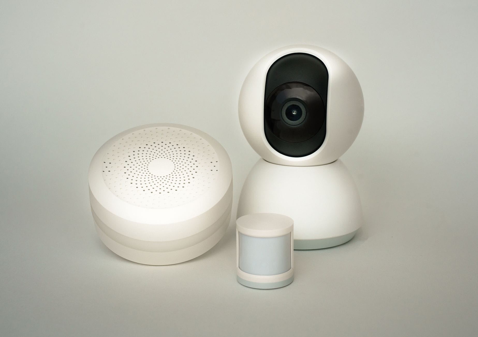 Nowoczesne urządzenia smart home: kamera i czujniki na jasnym tle